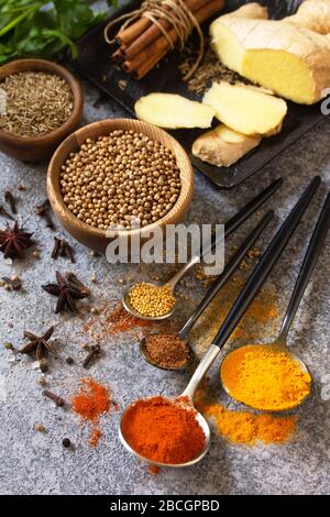 Various of Indian herbs and spices for cooking on a stone table. Stock Photo