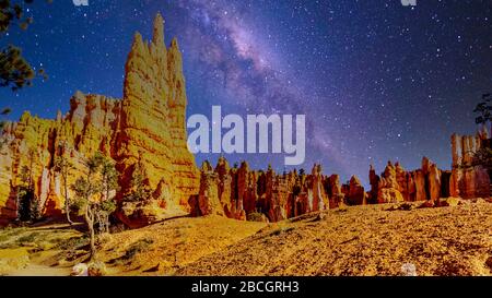Galaxy in the night sky over the natural vermilion colored hoodoos on the Queen's Garden Trail in Bryce Canyon National Park, Utah, United States Stock Photo