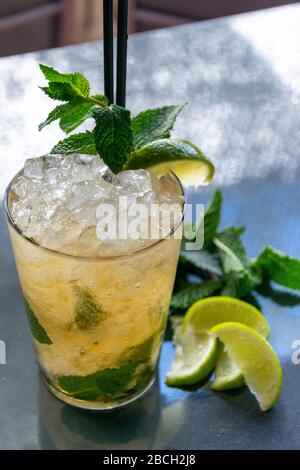 a chilled lime and mint Mojito cocktail drink with some ingredients alongside Stock Photo