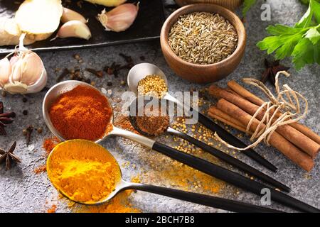 Various of Indian herbs and spices for cooking on a stone table. Stock Photo