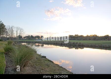 A view of the lake and green rolling landscape at Grand Villas at the World Golf Village in St. Augustine, Florida USA Stock Photo