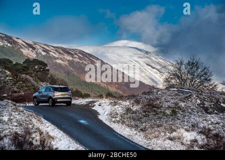 Typical Scottish panorama view, mountains, car on the road, Highlands, Scotland Stock Photo