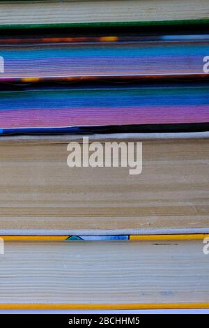 old school books stacked on each other, closeup of stacked old books, vertical shot Stock Photo