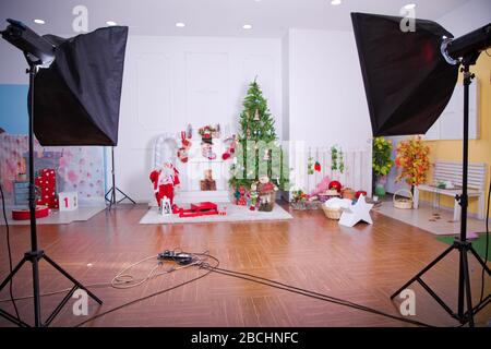 studio photo with softbox . Decorated Christmas room with beautiful tree . New Year's decor and tree in children's playroom. interior of a modern Stock Photo