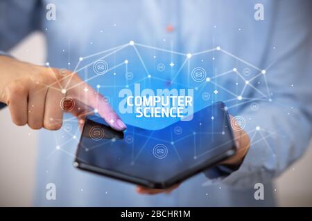 Businessman holding a foldable smartphone with COMPUTER SCIENCE inscription, new technology concept