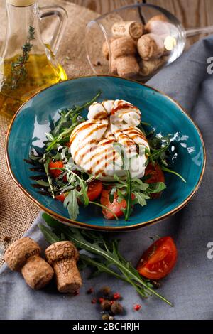 Cheese burrata and a salad for the weight loss lettuce, next to the ingredients to prigotovleniya Stock Photo
