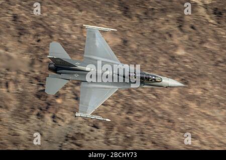 United States Air Force (USAF ) General Dynamics F-16 Fighting Falcon Fighter jet from Edwards AFB flying at low level in Death Valley California. Stock Photo