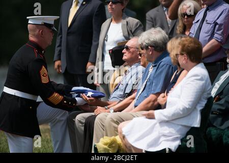 'U.S. Marine Corps Sgt. Maj. Joseph Gray, left, presents the American flag to Anthony Brozyna, nephew of U.S. Marine Corps Pfc. Anthony Brozyna, during the graveside service in Section 60 of Arlington National Cemetery, Aug. 31, 2016, in Arlington, Va. Brozyna, of Hartford, Connecticut, died Nov. 20, 1943 during the battle of Tarawa. His remains were recently recovered and identified. (U.S. Army photo by Rachel Larue/Arlington National Cemetery/released); 31 August 2016, 13:10; Graveside service for U.S. Marine Corps Pfc. Anthony Brozyna in Section 60 of Arlington National Cemetery; Arlington