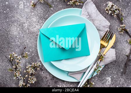 Spring table setting with envelope Stock Photo