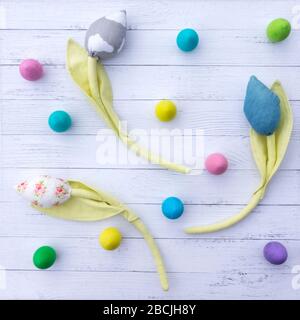Abstract Easter background with painted wooden eggs and handmade tulip flowers on bleached wooden boards. Funny dotted abstract background for wallpap Stock Photo