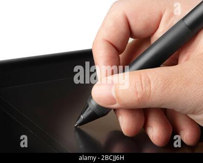 Hand is drawing on a digital graphic tablet with pen Stock Photo