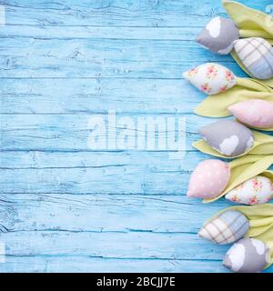 Rustic spring background for Mother's Day, International Women's Day or Easter greetings. Textile patchwork flowers tulips on aged blue boards. Floral Stock Photo