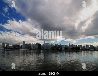 View From Stanley Park To Large Clouds Above The Vancouver Skyline Stock Photo
