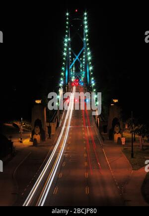 View From Stanley Park To The Lion's Gate Bridge In Vancouver At Night Stock Photo