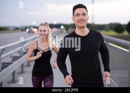 Man and woman doing sports outdoors Stock Photo