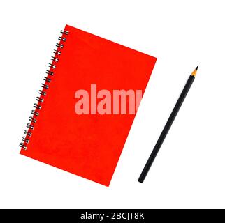 Portrait of a black pencil beside a red color covered single note paper diary isolated on an empty white background Stock Photo