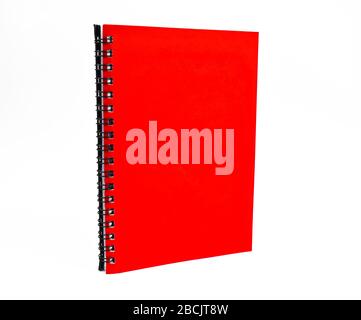 Portrait of a red color covered single note paper diary isolated on an empty white background Stock Photo