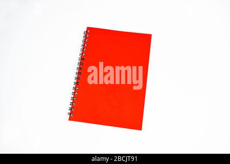 Red color covered single note paper diary isolated on an empty white background Stock Photo