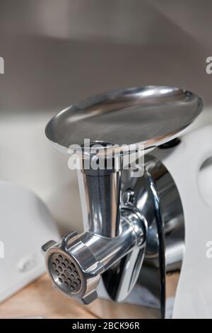 https://l450v.alamy.com/450v/2bck96r/new-metal-shiny-electric-meat-grinder-closeup-2bck96r.jpg