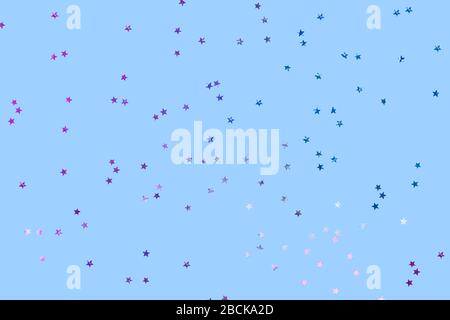 Falling confetti background. Sparkles on pastel blue trendy background. Festive backdrop for your projects. Stock Photo
