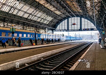 Lviv, Ukraine - December 28, 2019: Interior architecture of Lvov train station platform in historic Ukrainian city with tunnel arch, time and snow wea Stock Photo