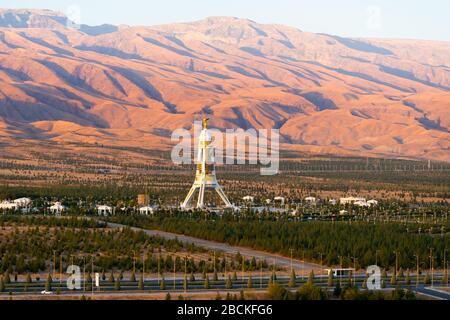 Kopet Dag Mountain Range and Neutrality Monument in Ashgabat, Turkmenistan. Also know as Turkmen-Khorasan mountains and Arch of Neutrality. Stock Photo