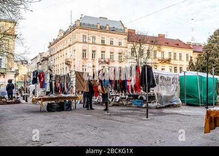 Lviv, Ukraine - January 21, 2020: Ukrainian Lvov city in old town with people at bazaar flea market selling clothing in center downtown in winter Stock Photo