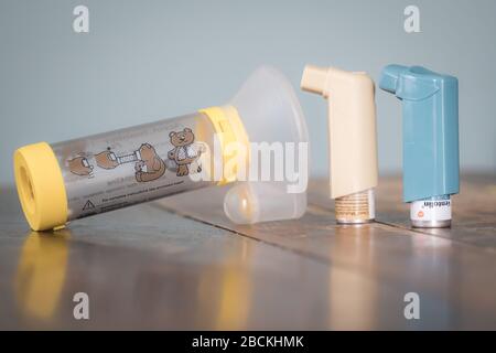 London, UK - April 3, 2020 - Clenil and Ventolin metered dose inhalers and Aerochamber spacer; commonly prescribed medications for asthma treatment Stock Photo