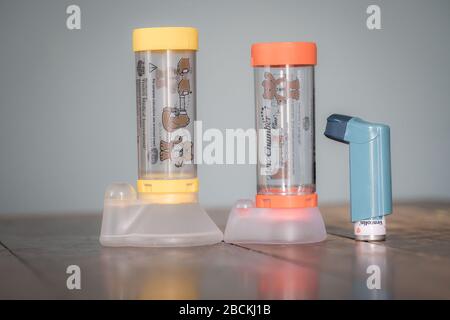 London, UK - April 3, 2020 - Ventolin inhaler and Aerochamber spacers (child and infant); commonly prescribed medication for asthma treatment Stock Photo