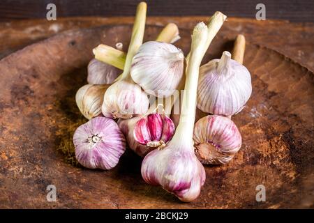 View of lots of heads of garlic on wooden background, healthy food Stock Photo