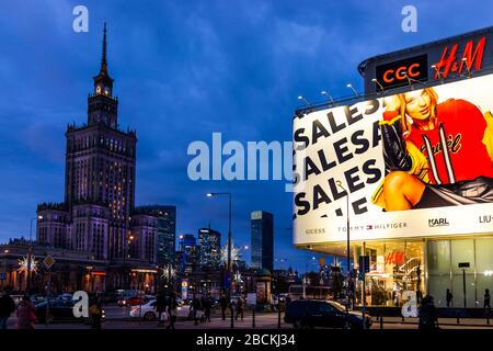 Warsaw, Poland - January 22, 2020: Warszawa centrum metro station area with famous Tower palace of science and culture buildings at night and advertis Stock Photo