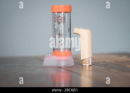 London, UK - April 3, 2020 - Clenil (beclomethasone) inhaler and infant Aerochamber spacer; commonly prescribed medication for asthma treatment Stock Photo