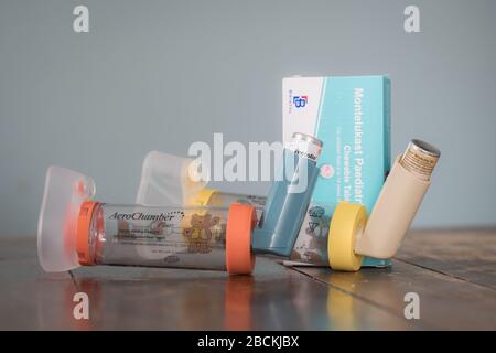 London, UK - April 3, 2020 - Ventolin and Clenil inhalers, montelukast tablets, Aerochamber spacers; common medications for asthma treatment Stock Photo