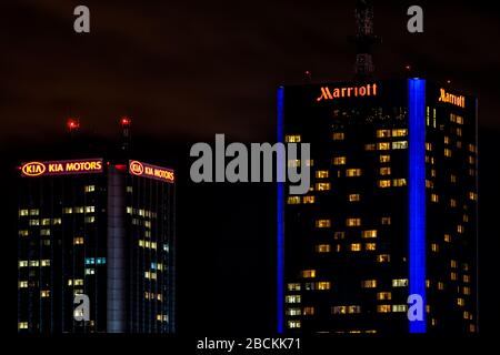 Warsaw, Poland - January 22, 2020: Warszawa Centralna central railway station area with closeup of illuminated hotel buildings at night with Kia Motor Stock Photo