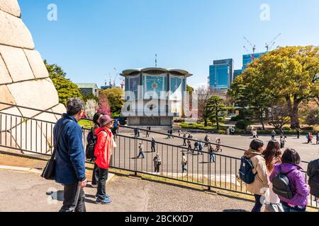 Tokyo, Japan - April 1, 2019: Imperial palace national gardens park with people at Edo period castle keep and Tokagakudo Imperial household agency dep Stock Photo