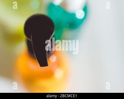 Cosmetic bottles with dispensers on a white table. Stock Photo