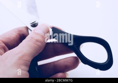 Female hand holds open stationery scissors close-up Stock Photo