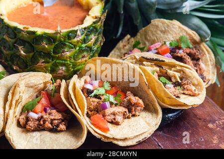 Tacos Al Pastor Shepherd's tacos, known as adobada tacos in the north of Mexico, spiced pork tacos with pineapple and spicy salsa Stock Photo