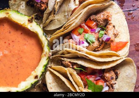Tacos Al Pastor Shepherd's tacos, known as adobada tacos in the north of Mexico, spiced pork tacos with pineapple and spicy salsa Stock Photo