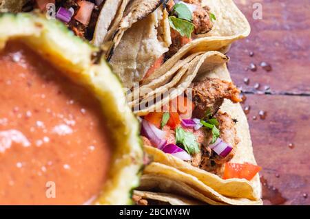 Tacos Al Pastor Shepherd's tacos, known as adobada tacos in the north of Mexico, spiced pork tacos with pineapple and spicy salsa Stock Photo