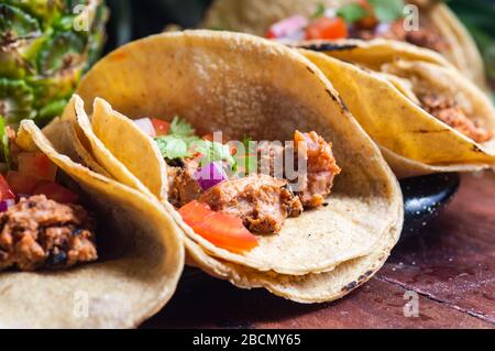 Tacos Al Pastor Shepherd's tacos, known as adobada tacos in the north of Mexico, spiced pork tacos with pineapple and spicy salsa Stock Photo