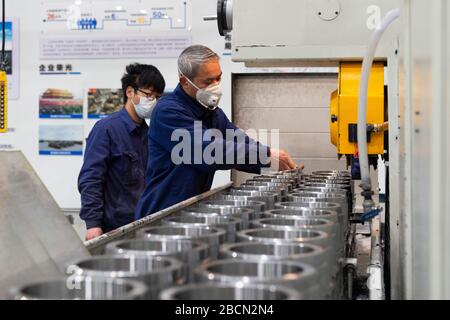 Xiangyang, China's Hubei Province. 3rd Apr, 2020. People work at the Hubei Jiangshan Heavy Industries Co., Ltd. in Xiangyang, central China's Hubei Province, April 3, 2020. The local authorities of Xiangyang has been promoting enterprises to resume operation and recover production capacities in an orderly manner recently. Credit: Xie Jianfei/Xinhua/Alamy Live News Stock Photo