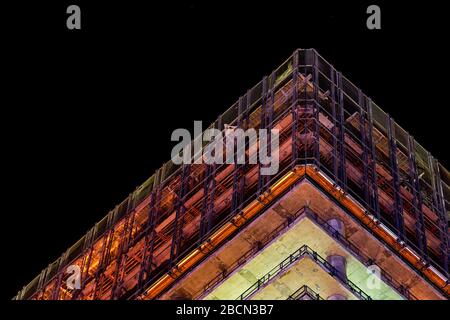 Looking up at a high rise construction site lit up at night in Perth during the boom Stock Photo