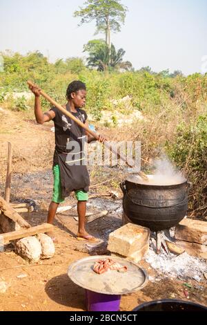 African woman cooking in a large pot, outside Stock Photo - Alamy