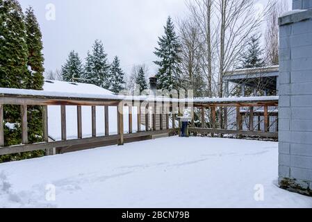 Fresh wet snow on a cedar deck, stormy snow day Stock Photo