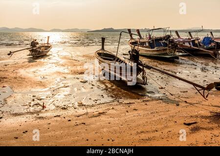 Beached boats at low tide during golden hour on Ko Yao Noi island in Phang-Nga Bay near Phuket, Thailand Stock Photo