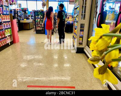 Santa Barbara, California, USA. 30th Mar, 2020. Safeway Grocery Store in Goleta, Ca institutes new social distancing procedures by putting red tape on the floors at least 6 week apart and only allowing one person at the checkout counter at a time. Credit: Amy Katz/ZUMA Wire/Alamy Live News Stock Photo