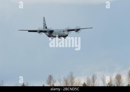 A U.S. Air Force C-130J Super Hercules approaches the runway at Joint Base Lewis-McChord, Wash., March 25, 2020. The C-130 carried U.S. Army Soldiers assigned to the 627th Hospital Center, Fort Carson, Colo., and equipment to set up a field hospital in Seattle, Wash. to help decompress bed space at local hospitals to enable them to treat patients infected with COVID-19. U.S. Northern Command, through U.S. Army North, is providing military support to the Federal Emergency Management Agency to help communities in need. (U.S. Air Force photo by Senior Airman Tryphena Mayhugh) Stock Photo