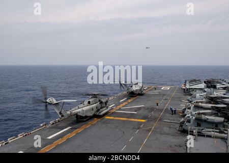 200327-N-DB724-2180 PHILIPPINE SEA (March 27, 2020) Two CH-53E Super Stallion assigned 31st Marine Expeditionary Unit (MEU), Marine Medium Tiltrotor Squadron (VMM) 265 (Reinforced) prepare to take off on the flight deck of amphibious assault ship USS America (LHA 6). America, flagship of the America Expeditionary Strike Group, 31st Marine Expeditionary Unit team, is operating in the U.S. 7th Fleet area of operations to enhance interoperability with allies and partners and serve as a ready response force to defend peace and stability in the Indo-Pacific region. (U.S. Navy photo by Mass Communic Stock Photo