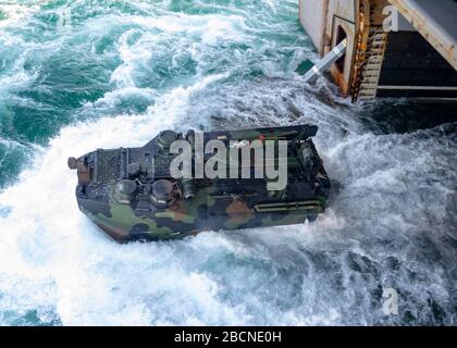 ONSLOW BAY, N.C. (March 18, 2020) – An Amphibious Assault Vehicle (AAV) assigned to 2nd Assault Amphibian Battalion (2nd AABN), 2nd Marine Division based out of Camp Lejeune, N.C. launches off the well deck onboard the Wasp-class amphibious assault ship USS Iwo Jima (LHD 7), March 18, 2020. Iwo Jima and the 2nd AABN are conducting amphibious assault operations certification in the Atlantic Ocean. (U.S. Navy photo by Mass Communications Specialist 3rd Class Jessica Kibena/Released) Stock Photo